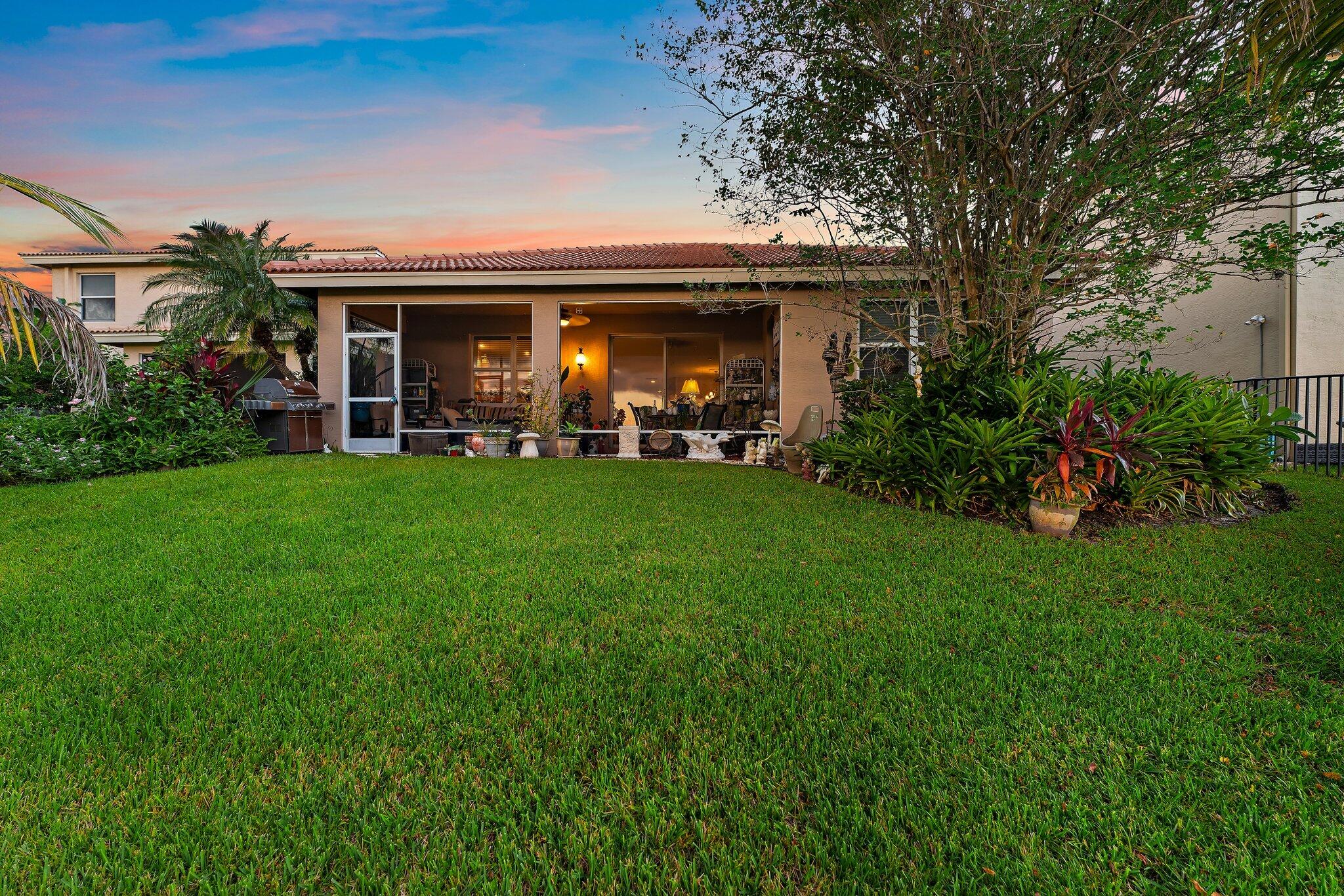 2912 Southwest Porpoise Circle Stuart, FL 34997 - Photo 5 of 36 front view of a house with a garden