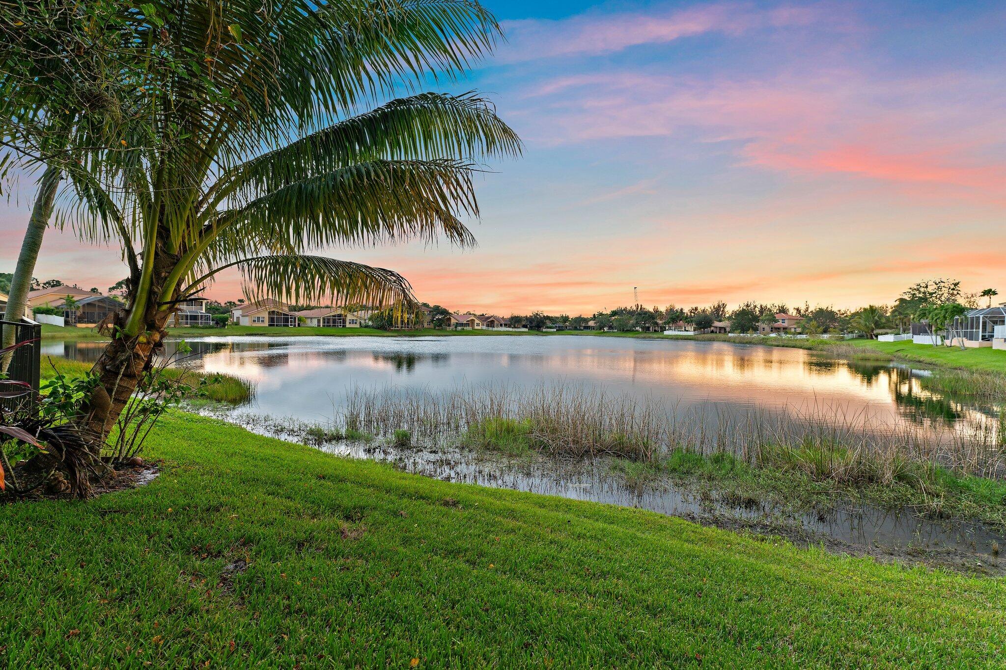 2912 Southwest Porpoise Circle Stuart, FL 34997 - Photo 6 of 36 a view of a lake with a big yard