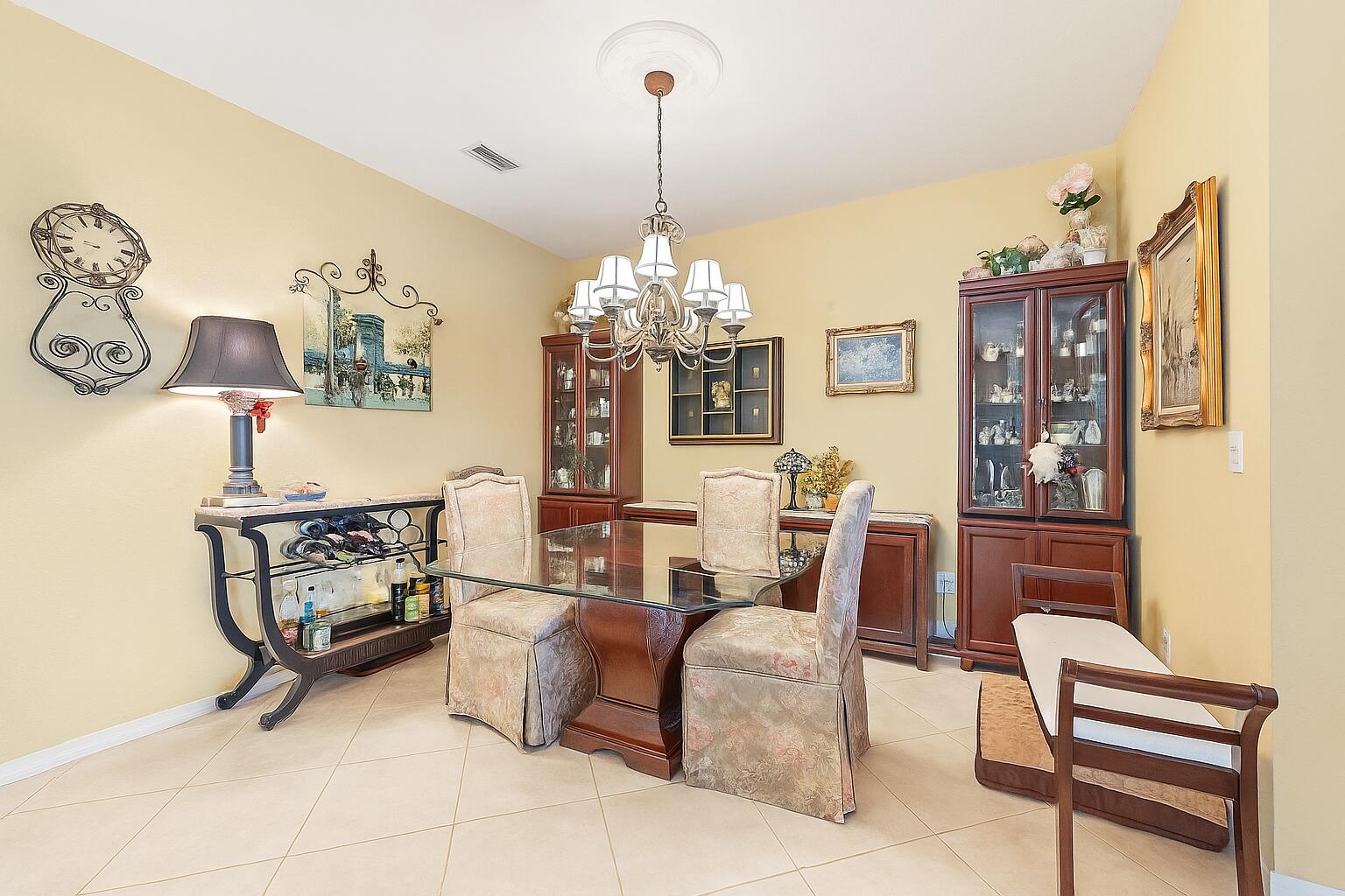 2912 Southwest Porpoise Circle Stuart, FL 34997 - Photo 9 of 36 a dining room with furniture and window