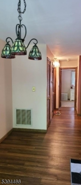 8 Steamboat Drive, Unit 11 Vernon, NJ 07462 - Photo 3 of 8 a view of empty room with wooden floor and fan