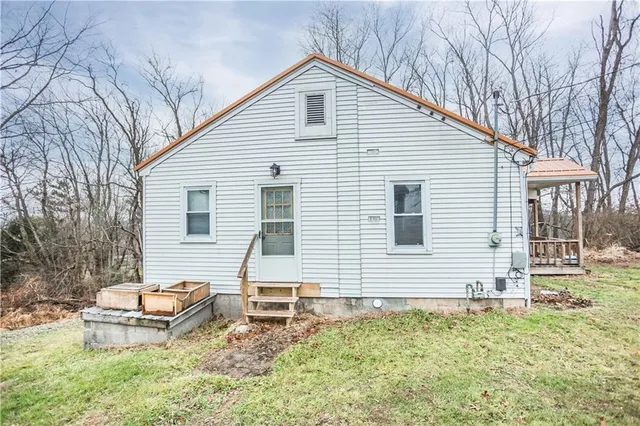 a backyard of a house with table and chairs