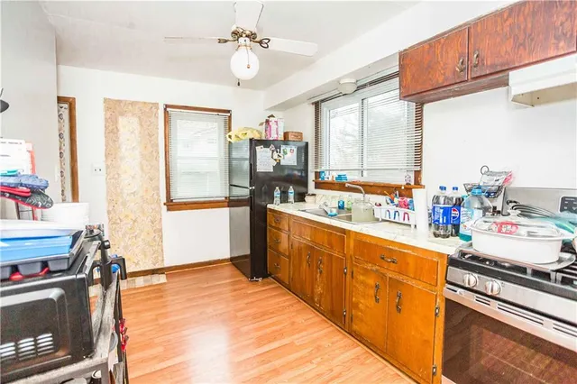a open kitchen with stainless steel appliances granite countertop a stove and a refrigerator