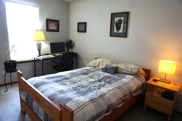 a bedroom with a bed and a desk