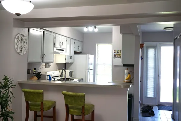 a kitchen with cabinets a sink and appliances