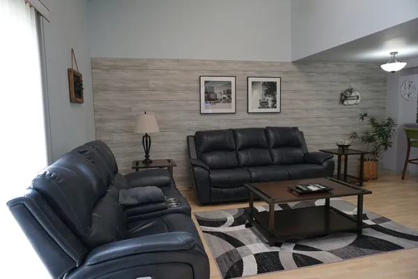 a living room with furniture and a wooden floor