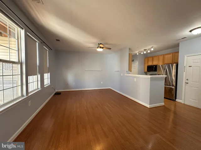 a view of a kitchen with a sink and a window