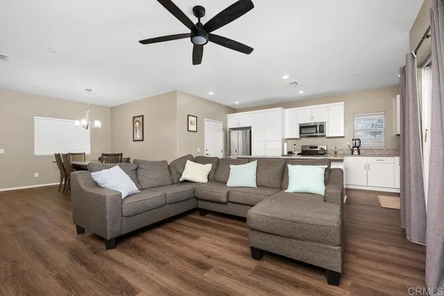 a living room with furniture and kitchen view