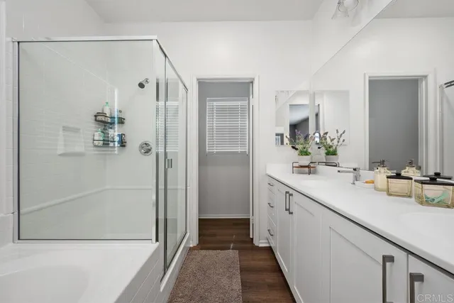 a bathroom with a double vanity sink and shower
