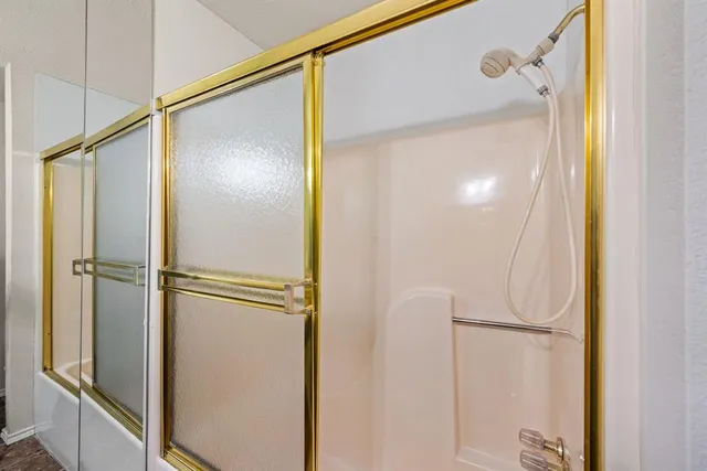 a bathroom with a glass shower door