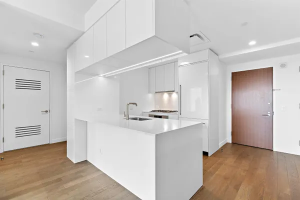 a kitchen with a sink stove and cabinets