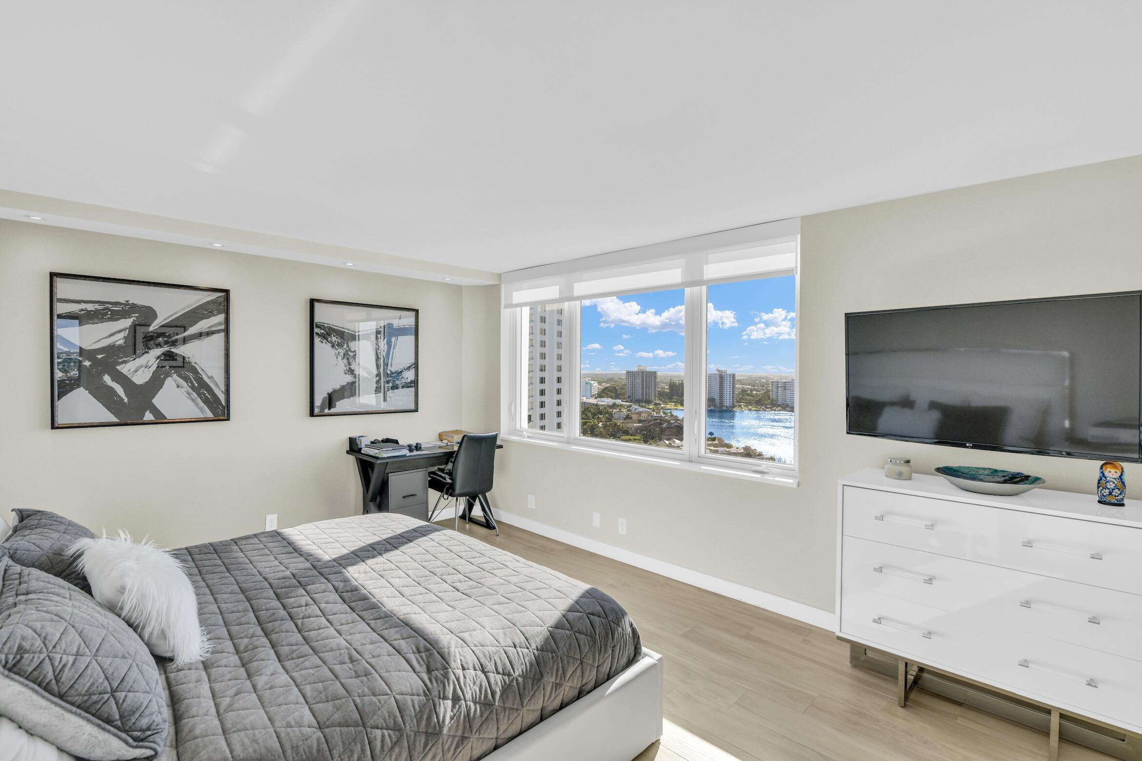 500 South Ocean Boulevard, Unit 1807 Boca Raton, FL 33432 - Photo 22 of 53 a bedroom with a bed and a flat screen tv