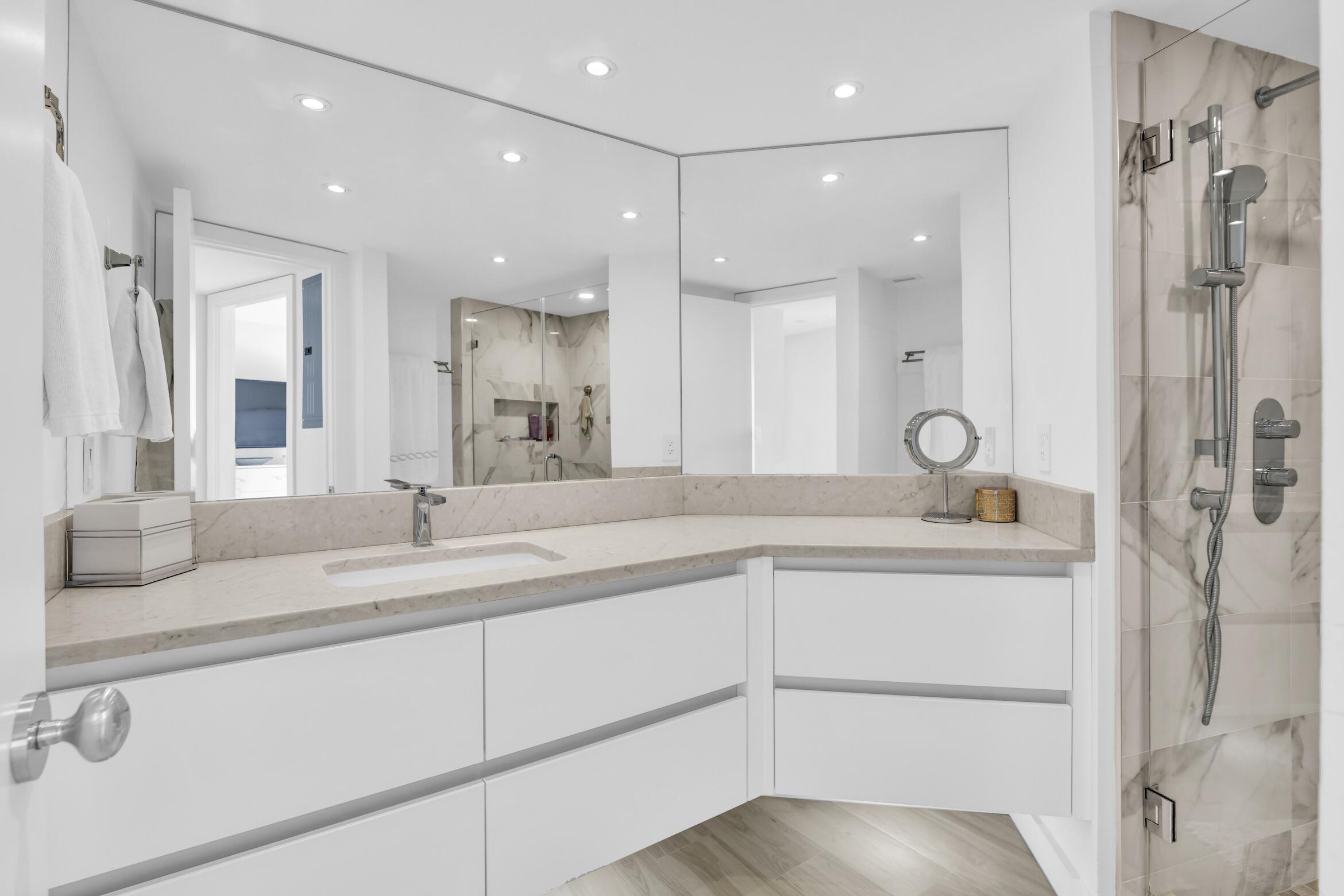 500 South Ocean Boulevard, Unit 1807 Boca Raton, FL 33432 - Photo 25 of 53 a bathroom with a sink and a mirror