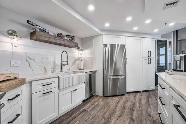 a kitchen with stainless steel appliances a refrigerator sink and cabinets