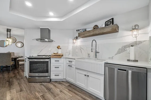 a kitchen with stainless steel appliances a stove and cabinets
