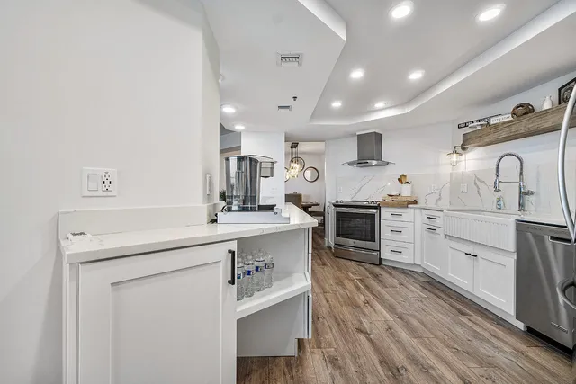 a kitchen with granite countertop a sink appliances cabinets and counter space