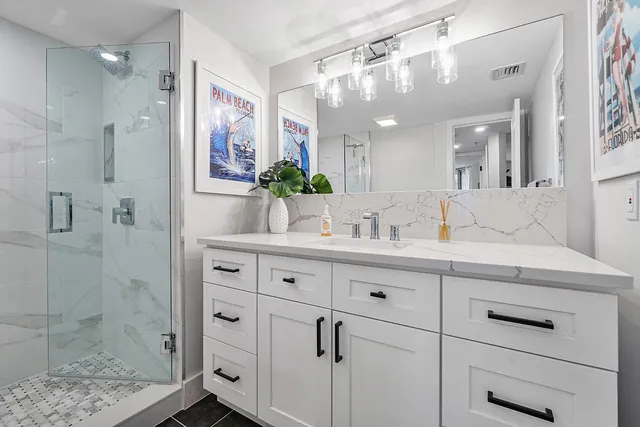 a bathroom with a shower sink and mirror