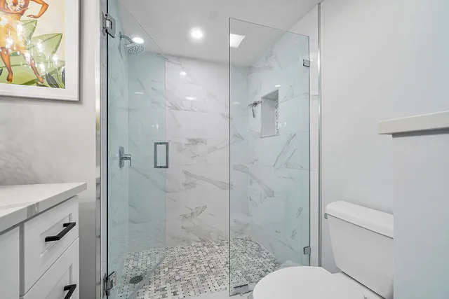 a bathroom with a shower toilet and sink
