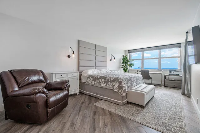 a bedroom with a bed and a couch