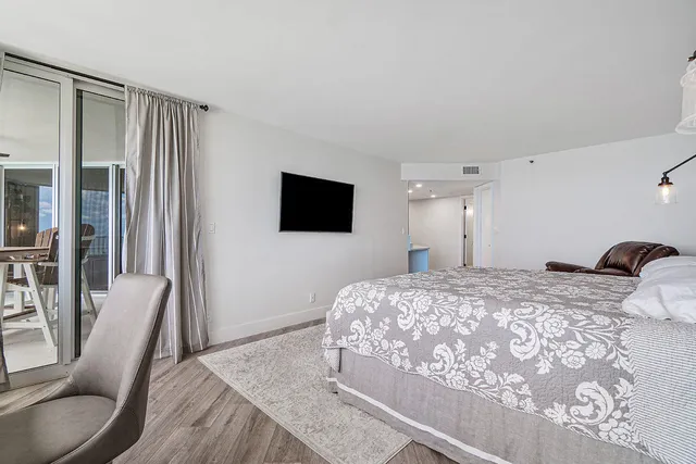 a bedroom with a bed and a flat screen tv