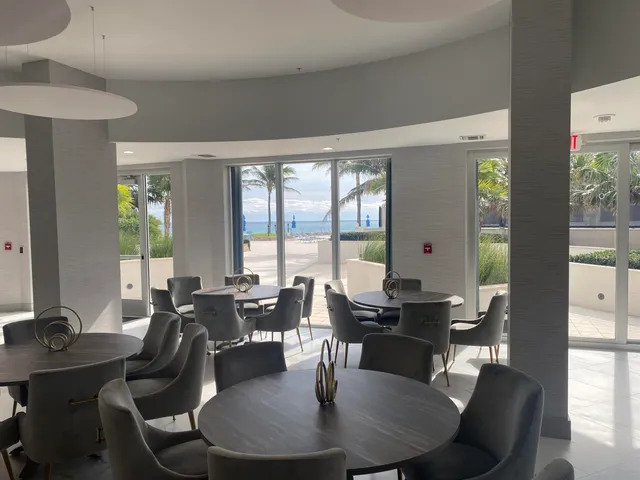a dining room with furniture a chandelier and wooden floor