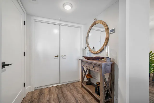 a view of a room with wooden floor and a bathroom