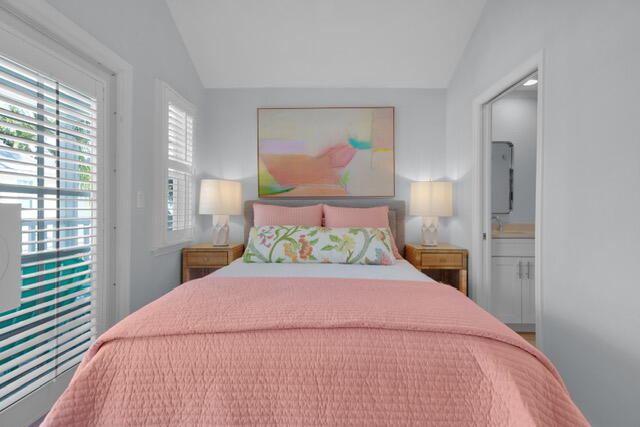 528 Porter Lane Key West, FL 33040 - Photo 16 of 27 a large bed sitting in a bedroom next to a window