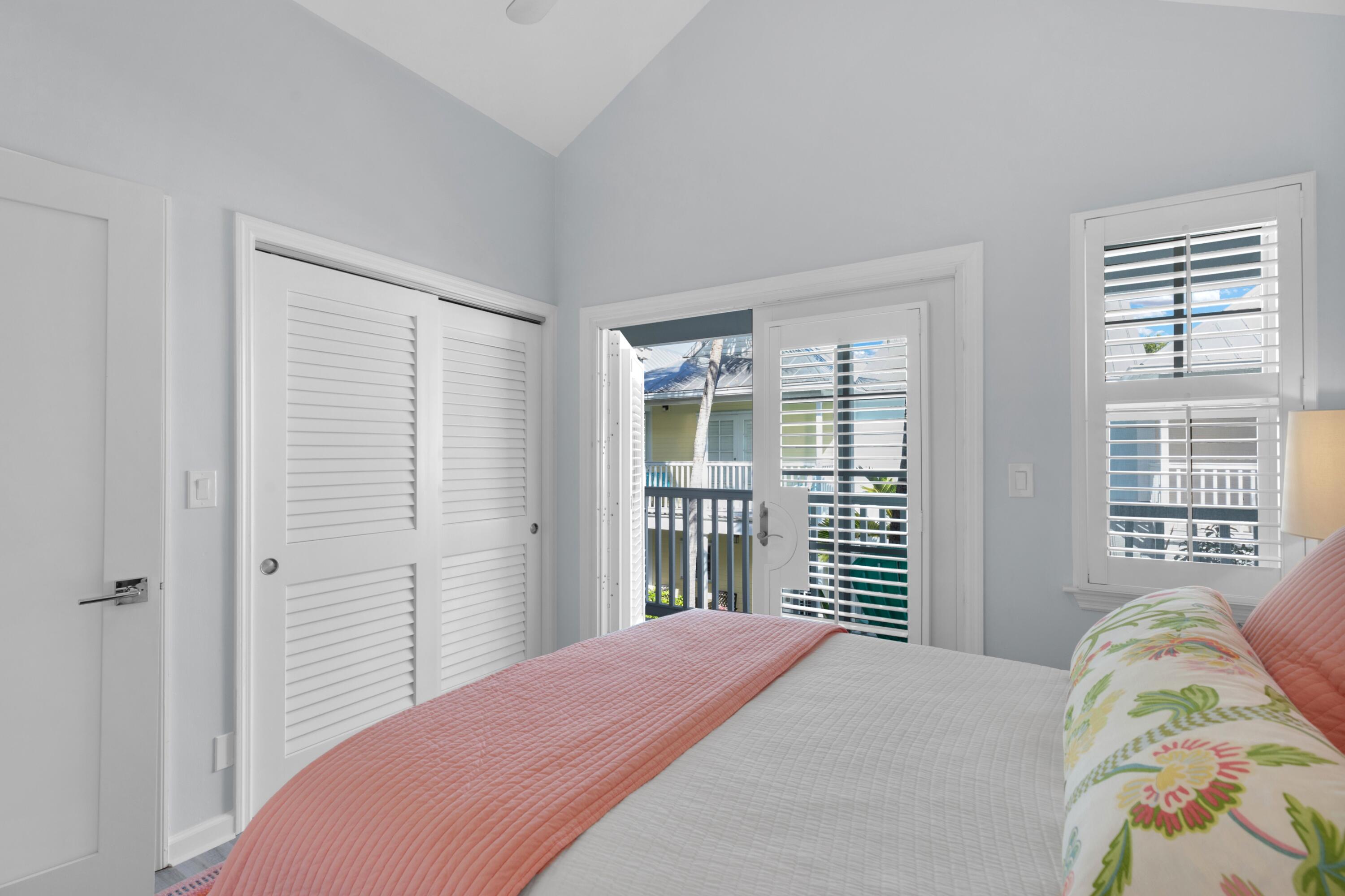 528 Porter Lane Key West, FL 33040 - Photo 17 of 27 a bedroom with a bed and a large window