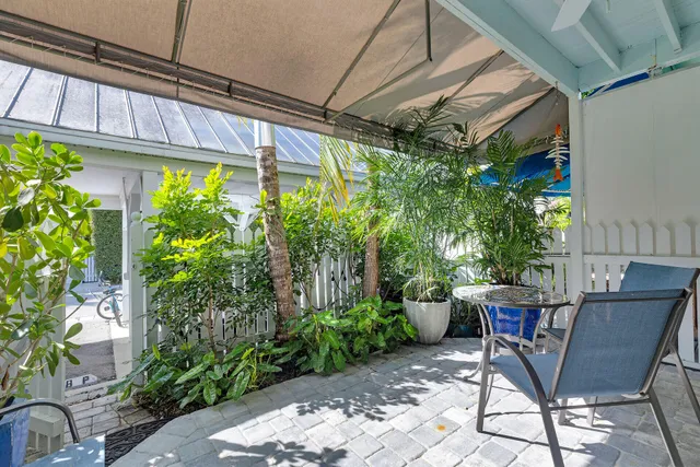 a view of a patio with a table and chairs