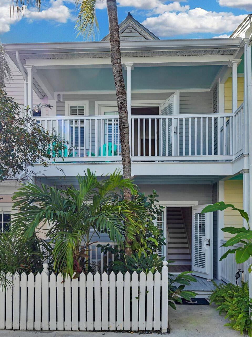 528 Porter Lane Key West, FL 33040 - Photo 25 of 27 a view of a house with brick walls and flower plants