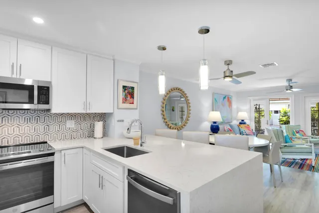 a kitchen with a sink a stove and cabinets