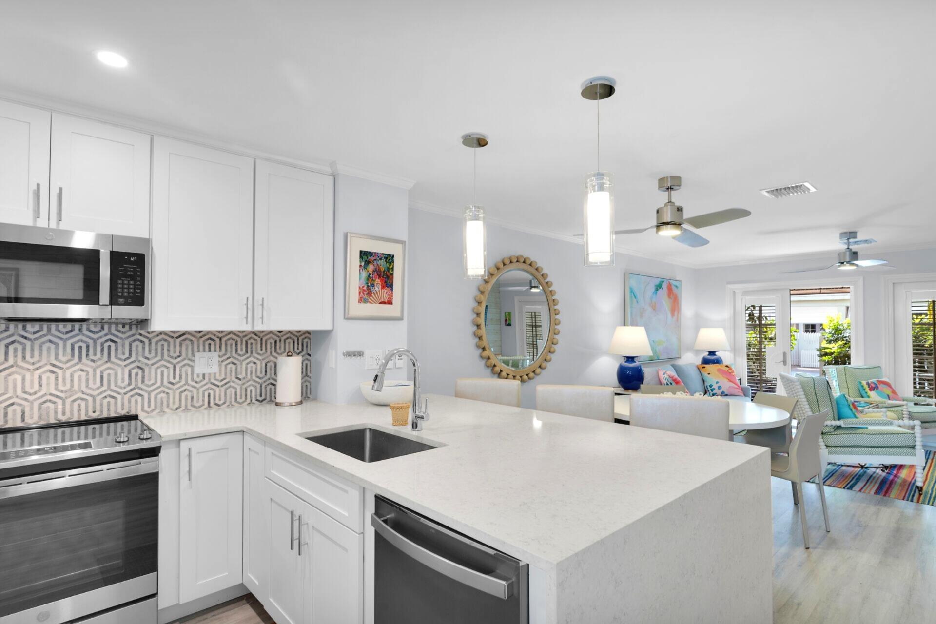 528 Porter Lane Key West, FL 33040 - Photo 5 of 27 a kitchen with a sink a stove and cabinets