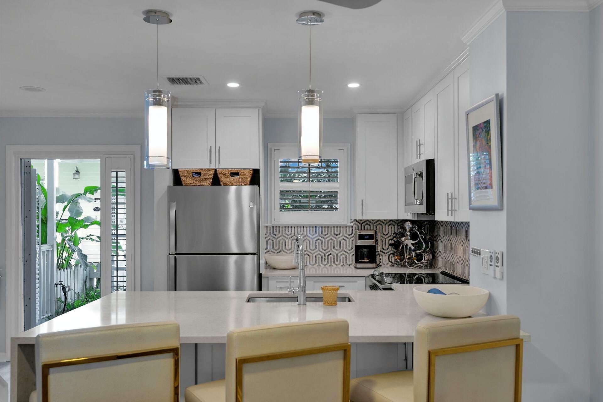 528 Porter Lane Key West, FL 33040 - Photo 7 of 27 a kitchen with kitchen island a sink stove and refrigerator