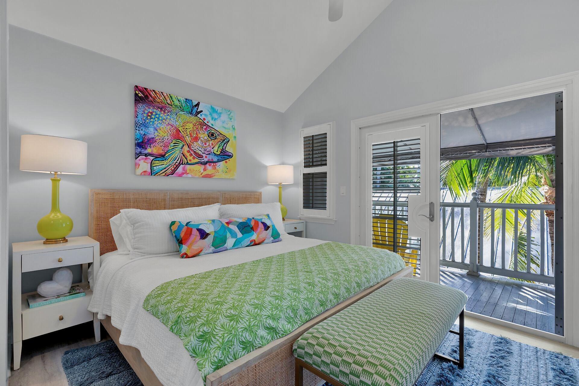 528 Porter Lane Key West, FL 33040 - Photo 9 of 27 a bedroom with a bed painting on wall and a potted plant