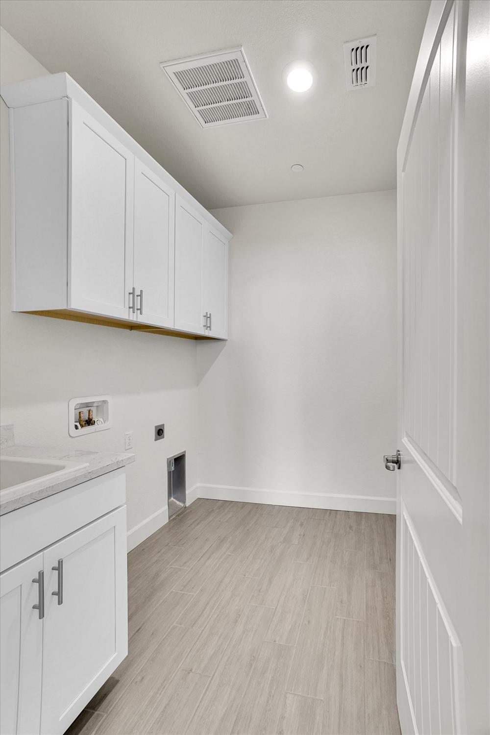 5280 Fandango Loop Roseville, CA 95747 - Photo 17 of 53 Upstairs laundry room with cabinets and sink.