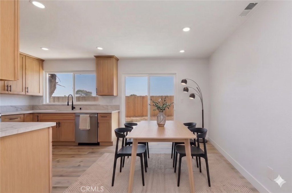 6940 Keating Drive Riverside, CA 92503 - Photo 6 of 15 a kitchen with a table chairs sink and cabinets