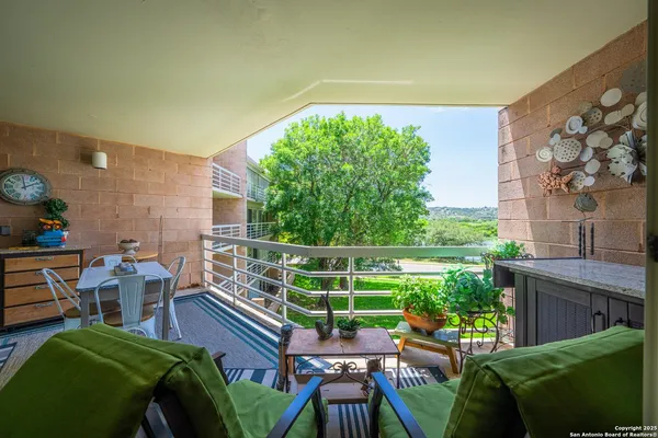 a view of a chairs and table in patio