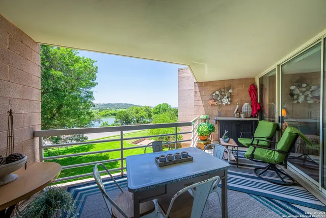a view of a chairs and table in patio with a yard