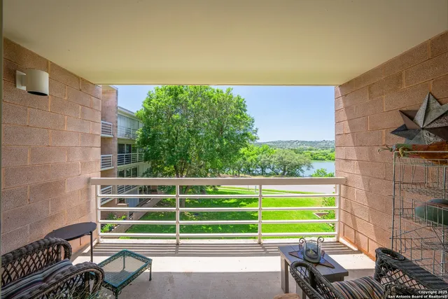 a view of a chair and table in the balcony