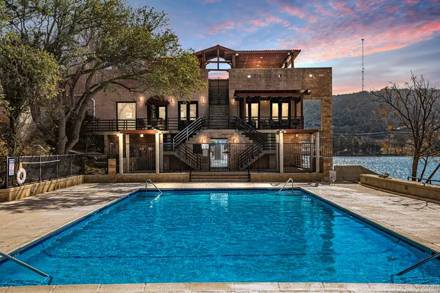 a view of a house with pool and yard