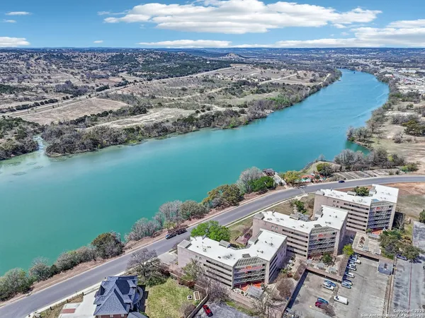 an aerial view of a house with a lake view