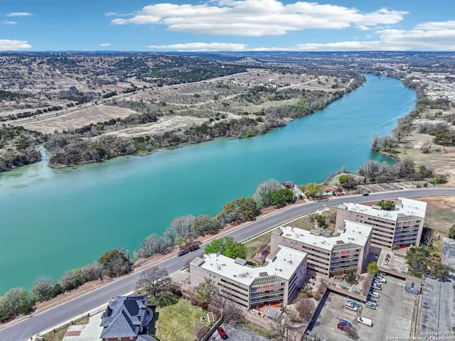an aerial view of a house with a lake view