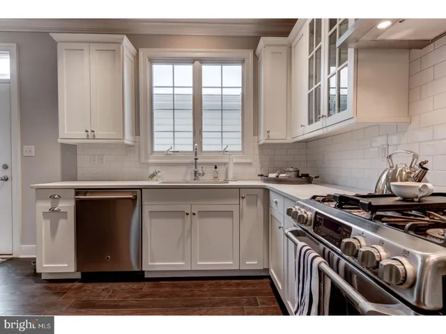 a kitchen with cabinets appliances and a window