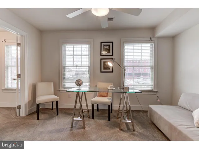 a living room with furniture and windows
