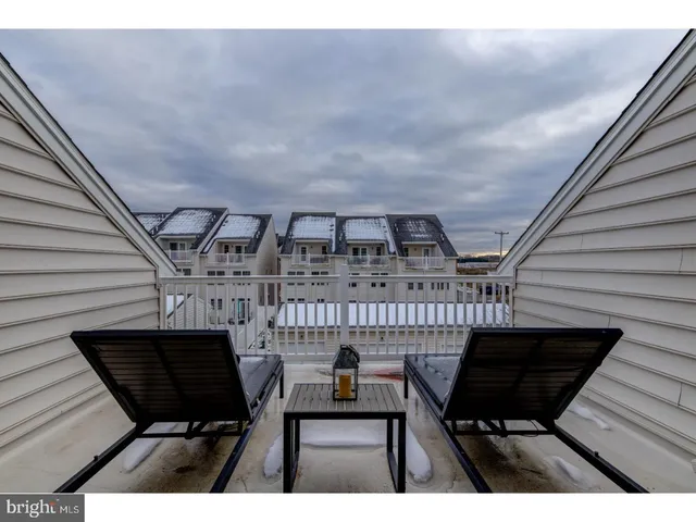 a view of a chairs and table in the balcony