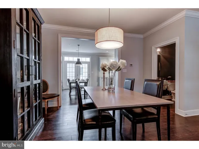 a view of a dining room with furniture wooden floor and chandelier