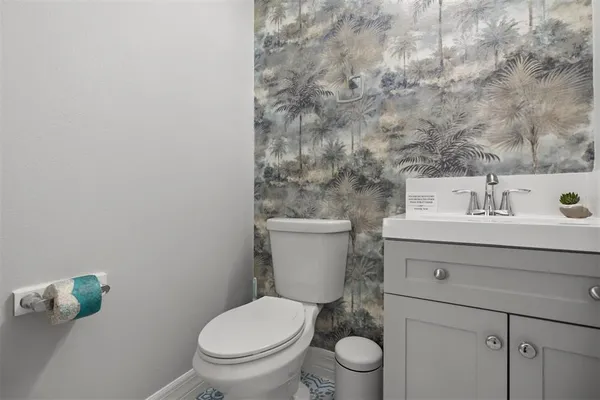 a bathroom with a sink a toilet and shower curtain