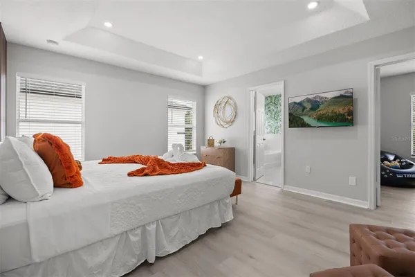 a bedroom with a bed and wooden floor
