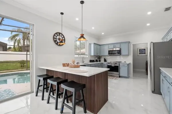 a kitchen with stainless steel appliances a sink a stove and a window