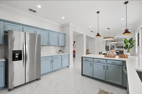 a kitchen with stainless steel appliances granite countertop a stove a refrigerator and a microwave