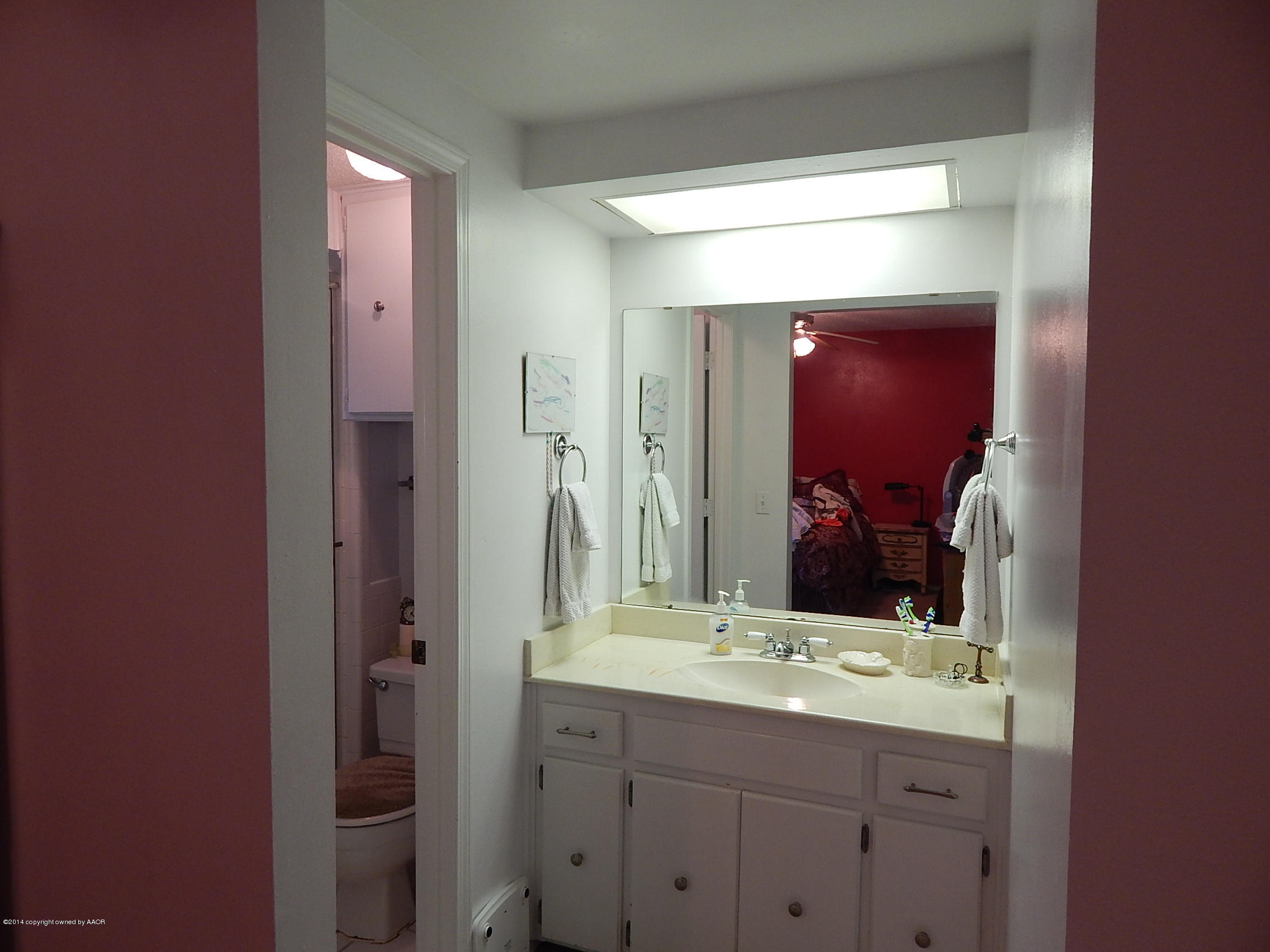 5203 Shield Drive Amarillo, TX 79110 - Photo 8 of 16 a bathroom with a granite countertop sink vanity and mirror